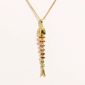 Detailed close-up of flexible fish pendant with colorful cubic zirconia and gold chain