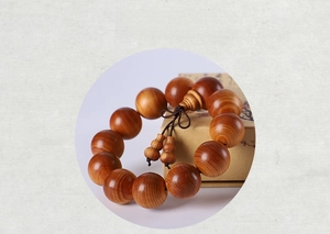 Detailed close-up of aged Thuja sutchuenensis wood beads with natural wave patterns