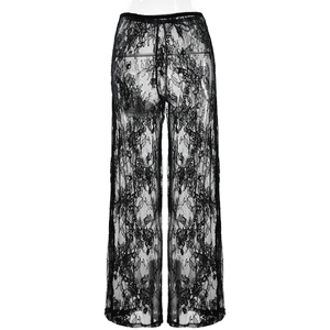Detailed close-up of semi-sheer black lace fabric and elastic waistband on wide leg trousers