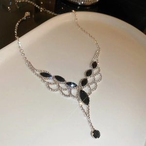 Detail of silver Y-shaped tassel necklace with black marquise stones and crystal accents