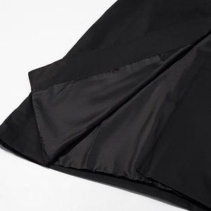 Detail of premium black lining and high-quality stitching on a long oversized trench coat