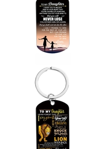 Detail view of military-style keychains with inspirational messages to my daughter