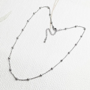 Detail of silver beaded chain necklace with lobster clasp and adjustable extension link