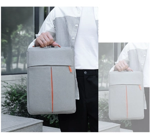 Slim light grey laptop sleeve with orange accents and convenient carrying handle