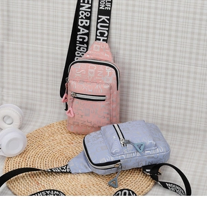 Detail of pink and purple chest bags with silver heart prints and wide lettered straps