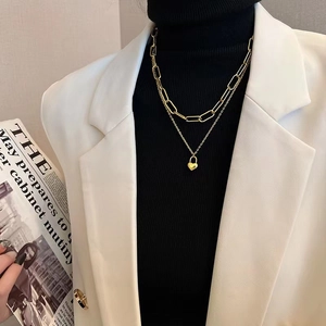 Double-layer gold titanium steel necklace featuring a paperclip chain and heart lock pendant