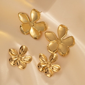 French vintage gold-plated floral stud earrings in two sizes on champagne satin fabric
