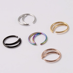 Close-up of double layered nose rings in silver gold rose gold black and rainbow colors