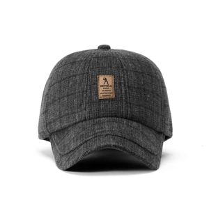 Close-up of winter wool baseball cap featuring premium brown leather brand patch detail