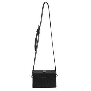 Close-up of black ostrich pattern box bag with silver metal buckle and adjustable strap