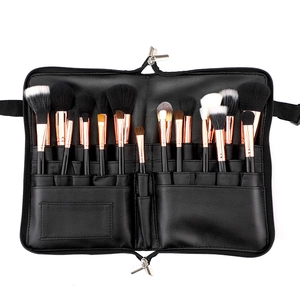 Detail view of foldable makeup brush case with organized compartments and brushes