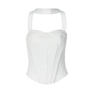 Dettaglio di un top a corsetto bianco con pizzo floreale e struttura con stecche
