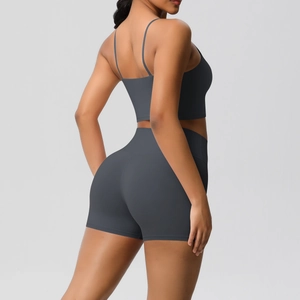 Detail of high-waisted charcoal yoga shorts and criss-cross back sports bra set
