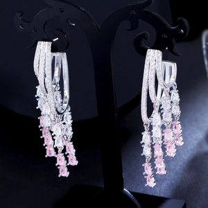 Detailed macro view of S925 silver fringe earrings with pink drop-shaped zircon crystals