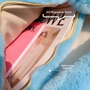 Interior view of blue faux fur shoulder bag showing large capacity for A4 magazines