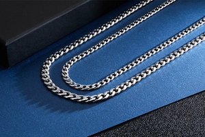 Macro detail of polished silver stainless steel NK link chain with glossy metal finish