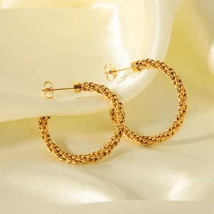 18K gold plated stainless steel C-shaped twisted hoop earrings on beige fabric