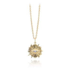 Macro shot of gold sunburst Evil Eye pendant featuring a central sparkling white zircon