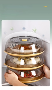 Close-up of three-tier stackable food covers with transparent brown lids and yellow trays