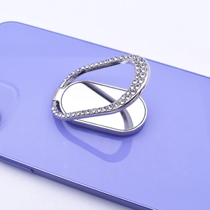 Detail of silver rhinestone oval phone ring holder attached to a purple smartphone