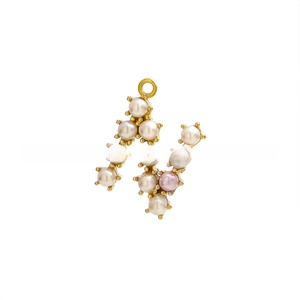 Macro detail of gold letter N pendant with white and pink pearls on a plain background