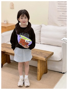 Close-up of girl wearing a purple nylon crossbody bag with cartoon bus design detail