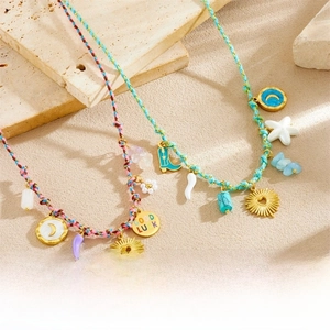 Detail of colorful woven cord necklaces with gold pendants and Good Luck charms