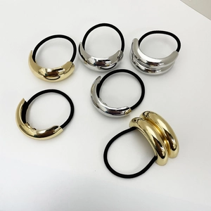 Detailed view of elastic hair bands with metallic gold and silver geometric accents