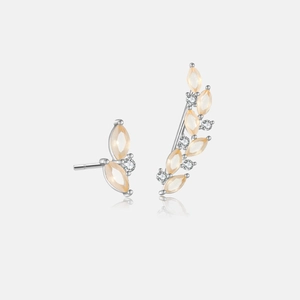 Detail of asymmetric 925 silver leaf earrings with orange gems and white zircon stones