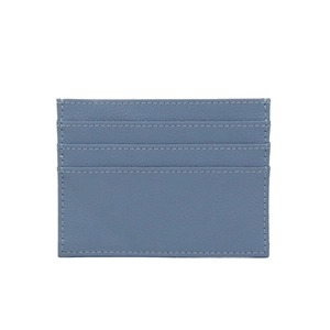 Detail of blue pebble grain leather card holder with precise white stitching and slots
