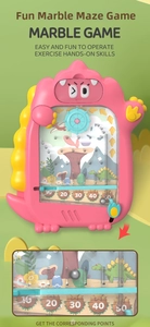 Close-up of pink dinosaur marble game toy showing internal track and score slots
