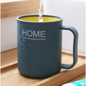 Two-tone blue and yellow mouthwash cup with handle and HOME text on wooden tray