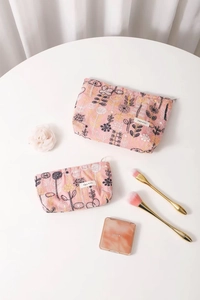 Detail of pink floral embroidery and zipper closure on the fabric makeup bag set
