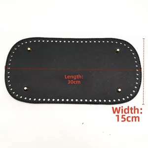 Detail of 30x15cm black PU leather bag base with golden feet and pre-punched holes
