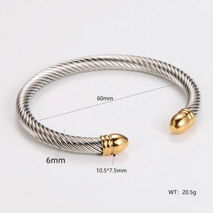 Detail view of two-tone cable twist bracelet showing 60mm diameter and 6mm width specs