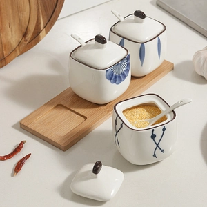 Japanese ceramic spice jar set with hand-painted blue patterns and bamboo tray