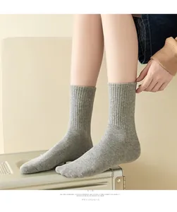 Close-up of gray cotton blend ribbed knit socks with vertical texture and elastic cuff