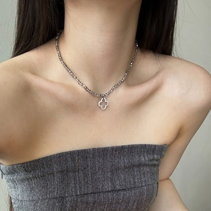 Detail of grey crystal beaded necklace with sparkling silver clover flower pendant