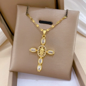 Macro shot of gold cross necklace with Mary relief and sparkling cubic zirconia stones