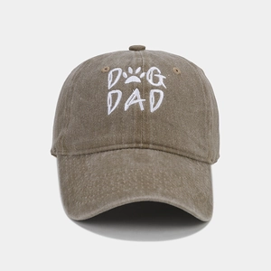 Close-up of DOG DAD white embroidery and paw print on washed cotton baseball cap