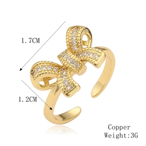 Macro detail of copper bow ring with micro-pave cubic zirconia and dimensions