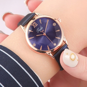 Macro detail of Tadi watch showing blue sunray dial and rose gold roman numerals