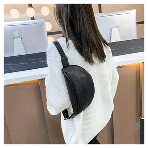 Detailed back view of a black crescent fanny pack in textured faux leather material