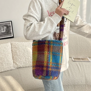 Detail of colorful plaid plush shoulder bag featuring a soft texture and large capacity