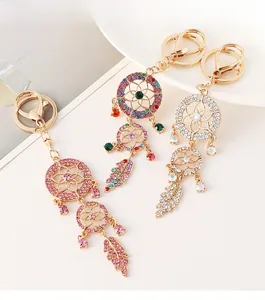 Detailed view of dreamcatcher keychains featuring colorful rhinestones and leaf charms