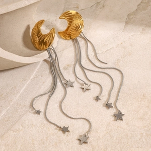 Detail of gold moon stud earrings with silver tassel chains and hanging star pendants