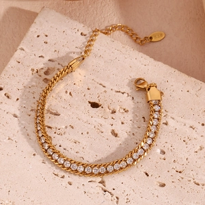 Detail of 18K gold plated woven chain bracelet with sparkling zircon stones and K18 tag