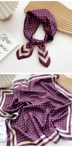 Detail of purple silk scarf with white polka dots and cream striped border texture