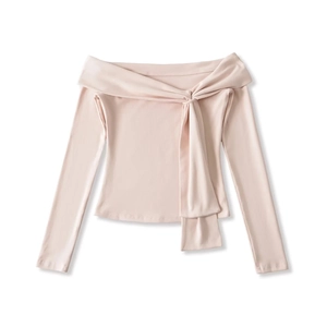 Detail of off-shoulder long sleeve top in pale pink with decorative knot feature
