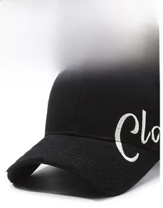 Detail of black cotton baseball cap showing white embroidery and distressed brim texture